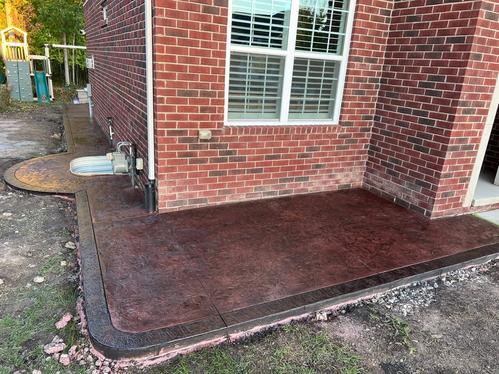 Stamped concrete patio — deep red finish