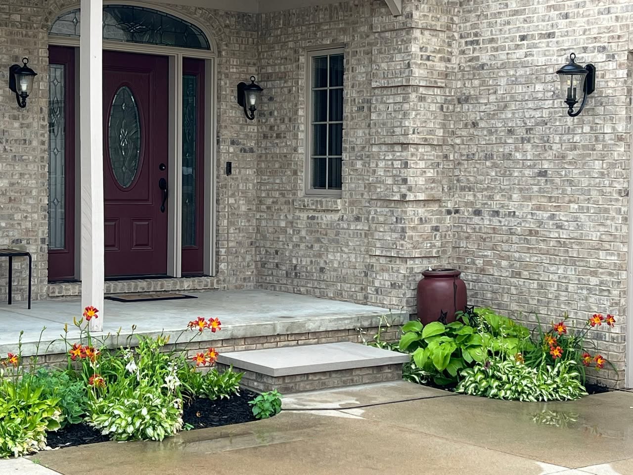 Custom brick-matched entry step at front door — original house brick reused