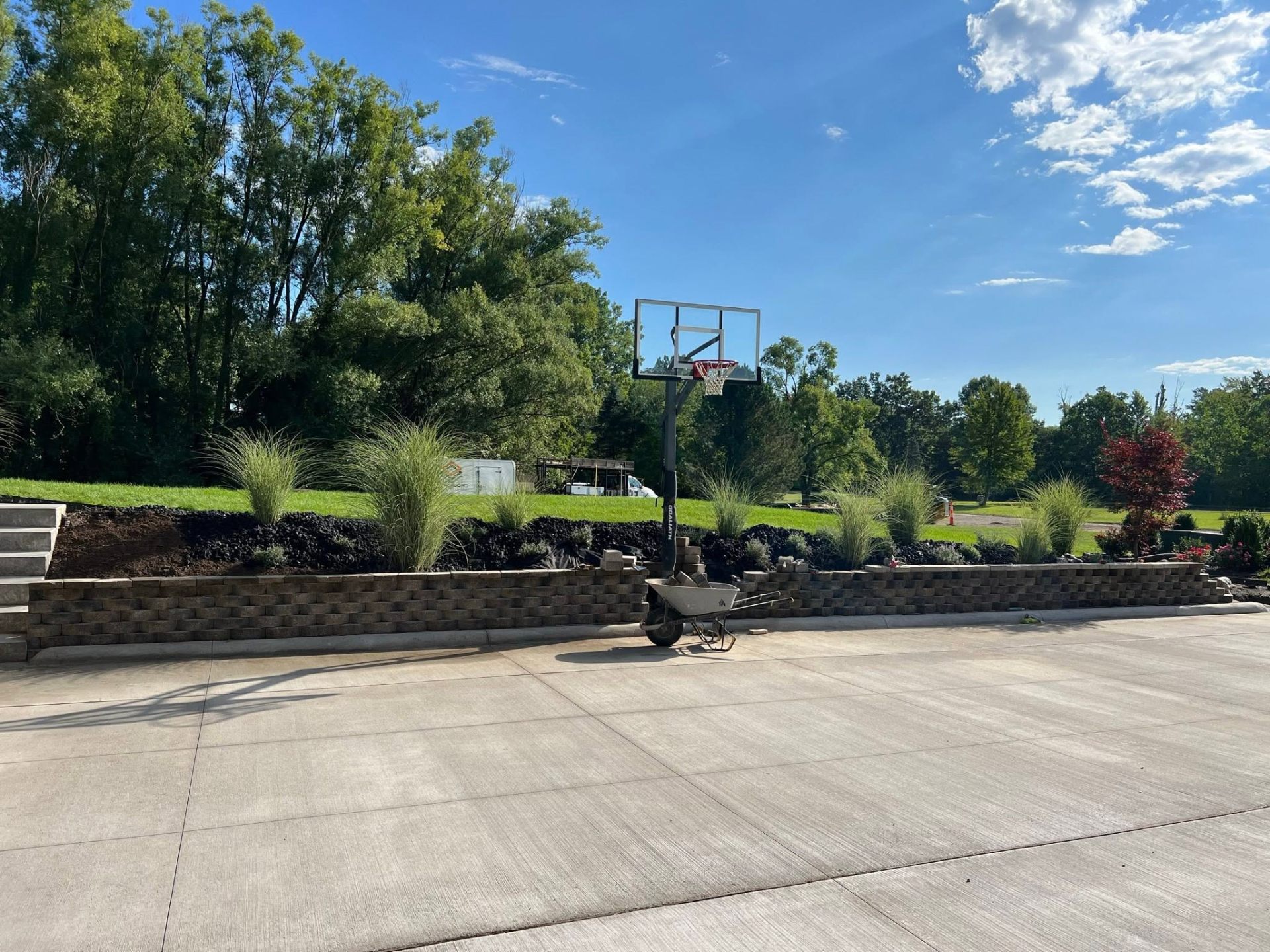 Court pad with finished block retaining wall