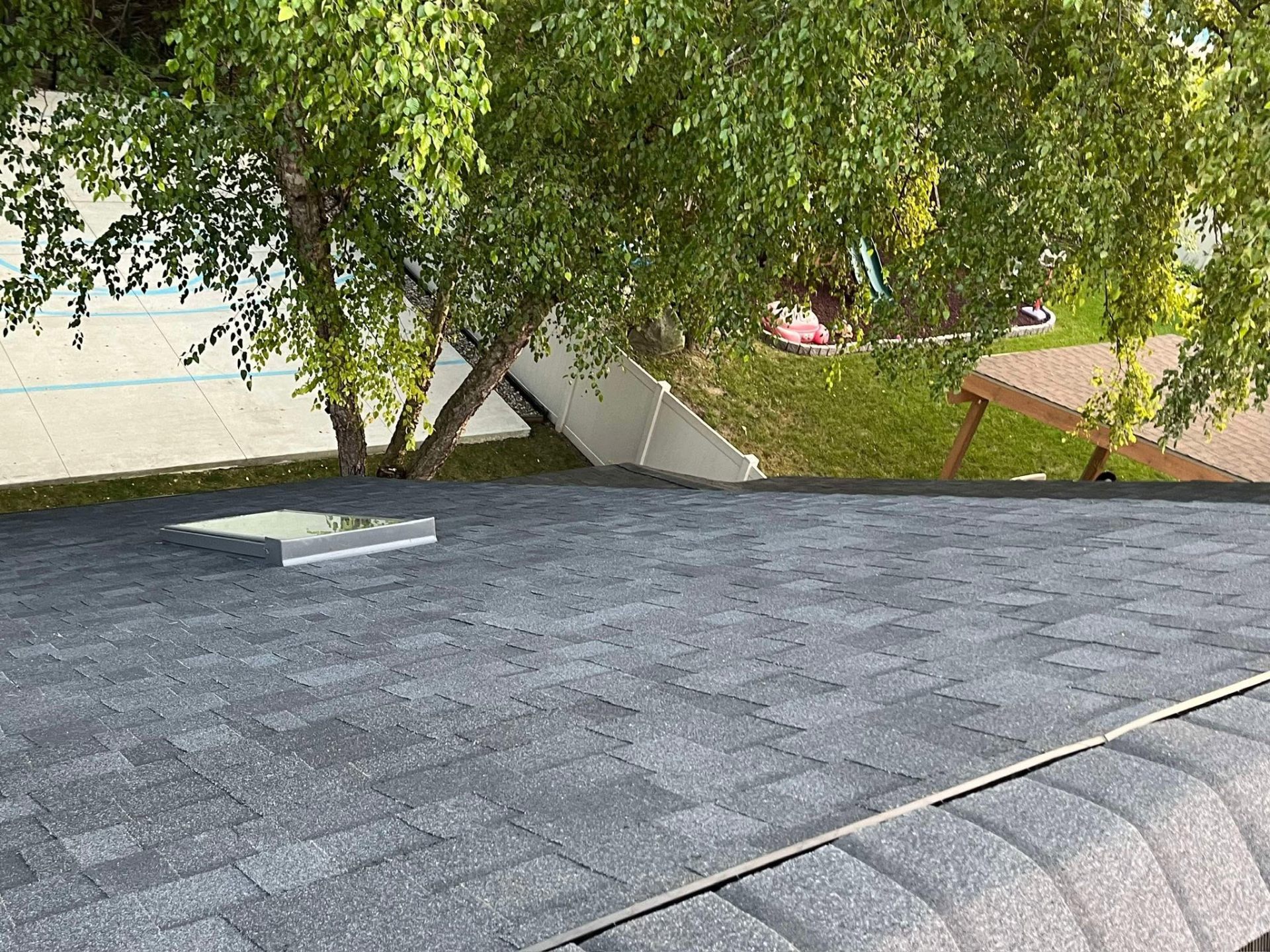 Backyard-facing roof with skylight and clean shingle field