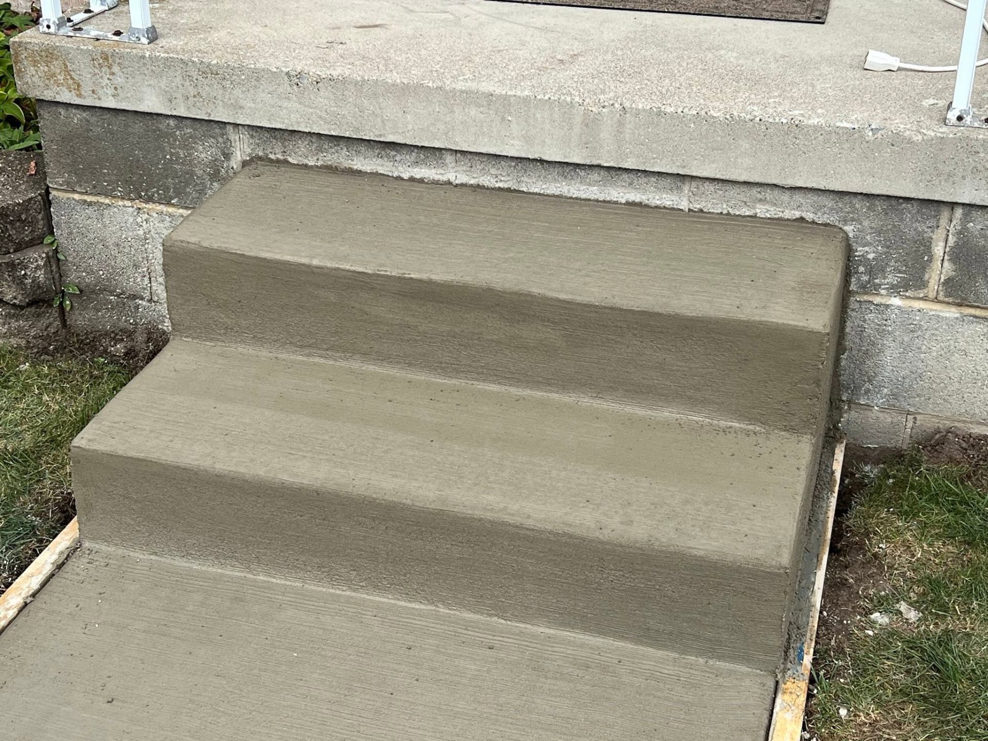 Small completed two-riser concrete entry steps