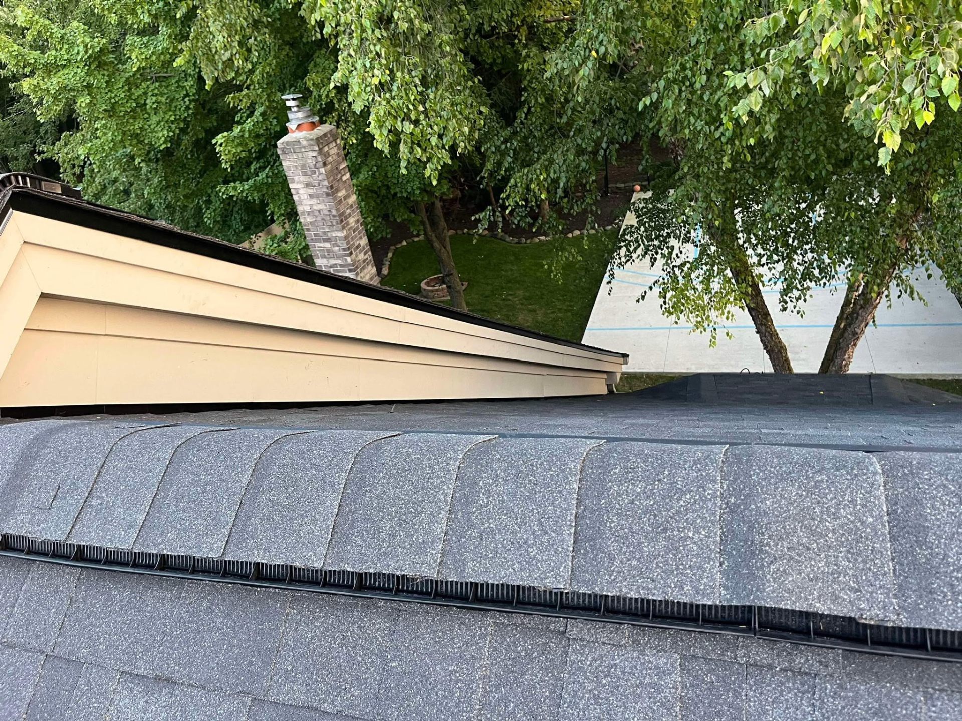 Ridge vent installation on completed shingle roof