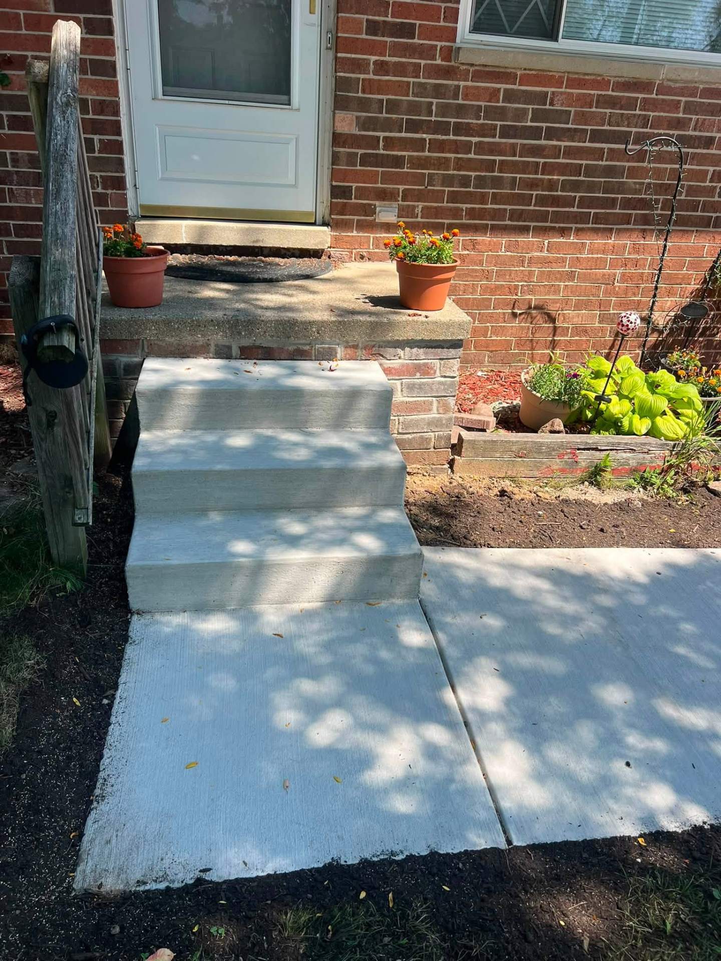 Close front-facing view of the newly poured concrete front steps