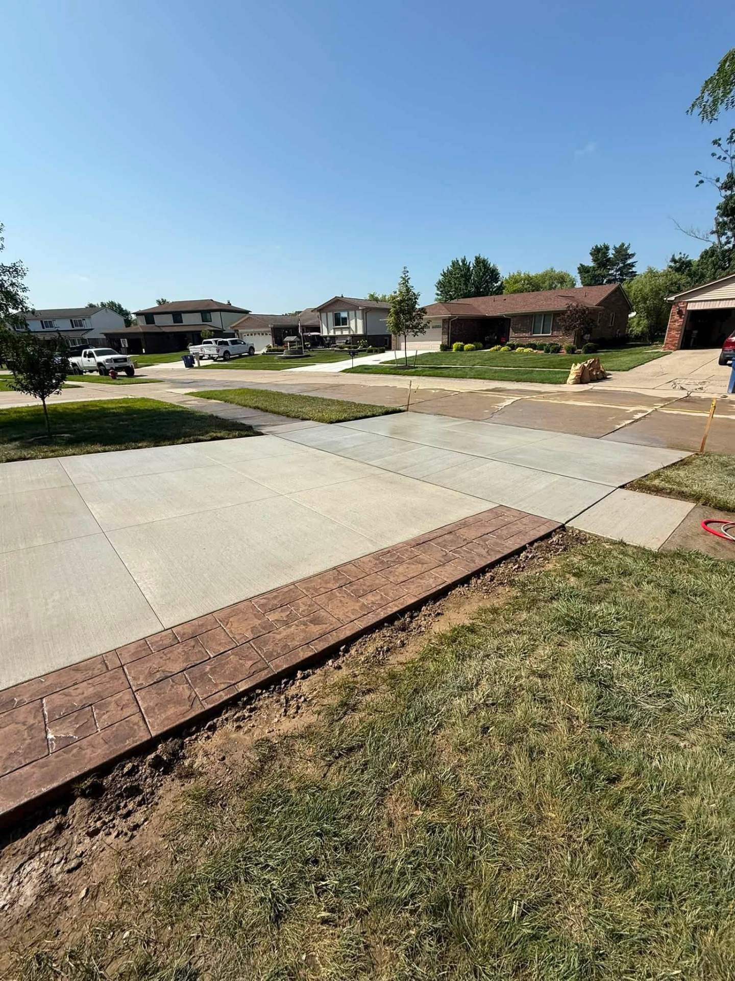 Concrete driveway approach with decorative stamped border