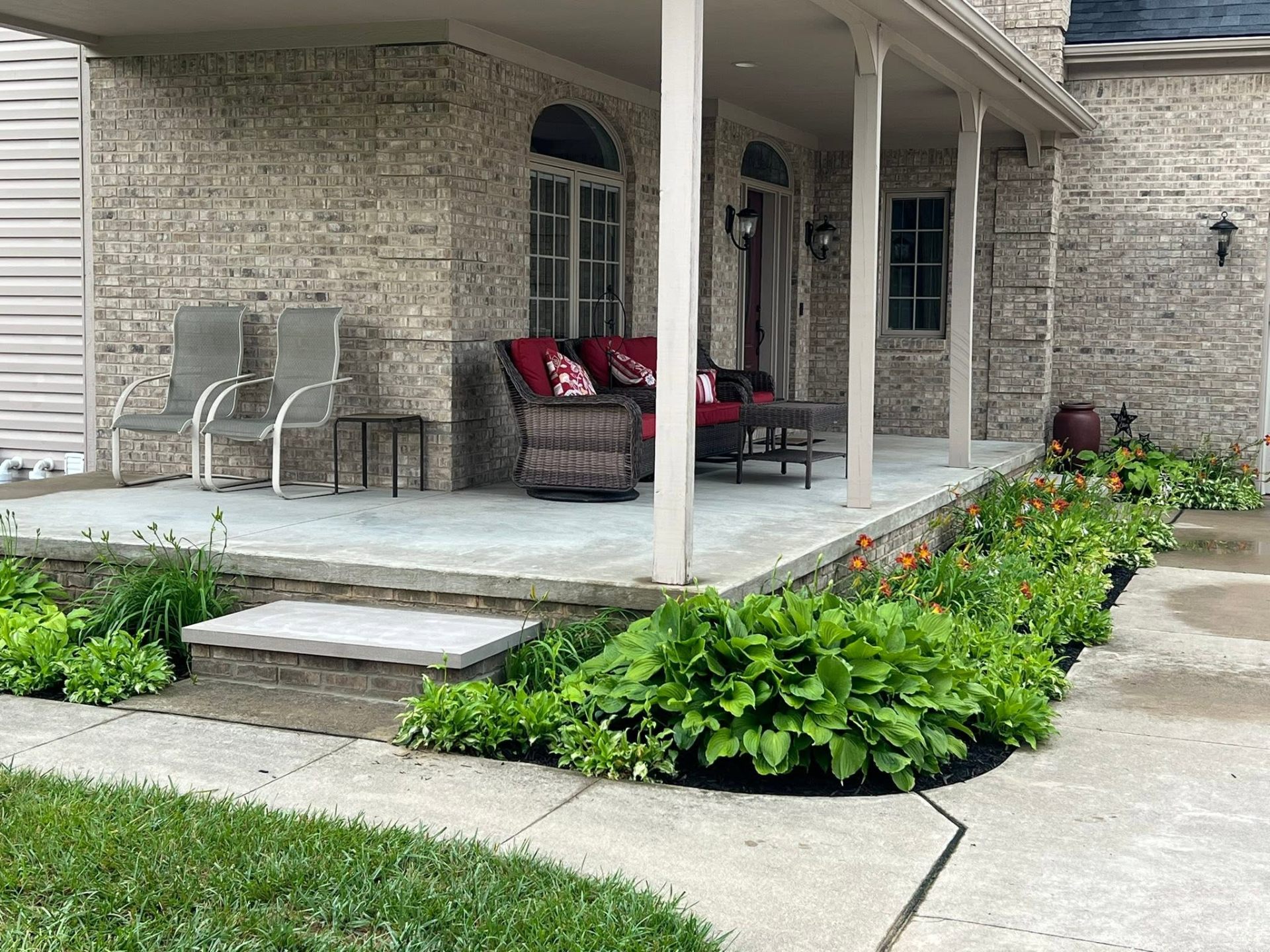 Front porch view of the custom brick step blending seamlessly into the 20-year-old brickwork