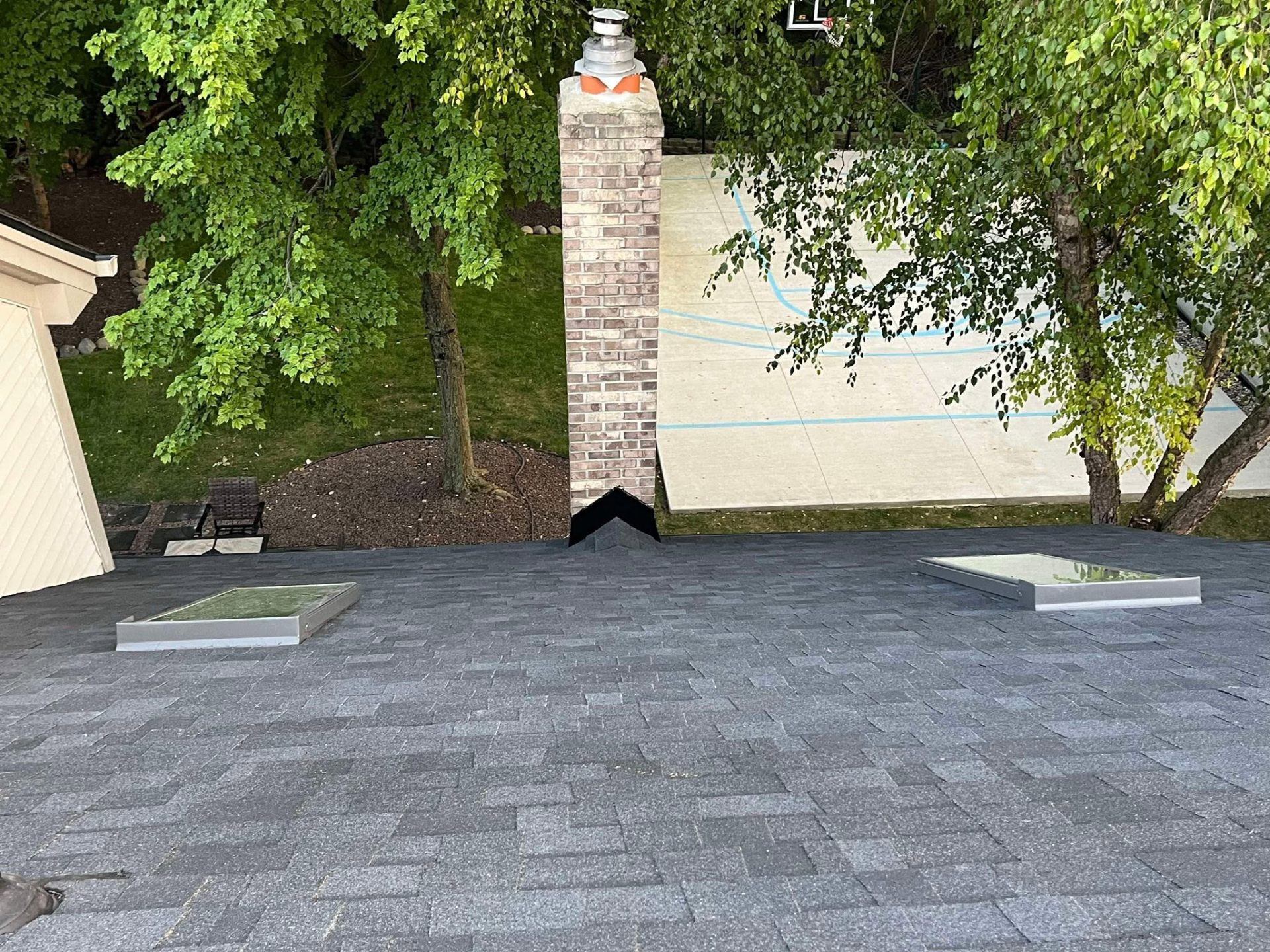 New roof with dual skylights and chimney flashing